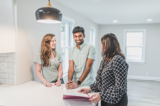 a landlord speaking with two tenants in a rental home